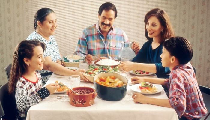 A Hispanic family having meal together.
