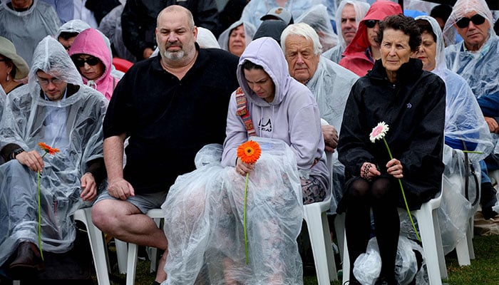 People attend a commemoration ceremony to mark the 20th anniversary of the Bali bombings, at Coogee Beach in Sydney on October 12, 2022. — AFP