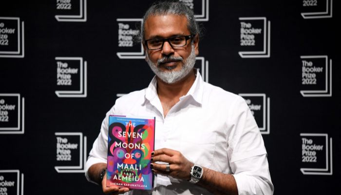 In this file photo taken on October 14, 2022 Sri Lankan author Shehan Karunatilaka holds his book ´The Seven Moons of Maali Almeida´ during a photocall at the Shaw Theatre in King´s Cross in London, ahead of Monday´s announcement of the winner of the 2022 Booker Prize for Fiction.— AFP