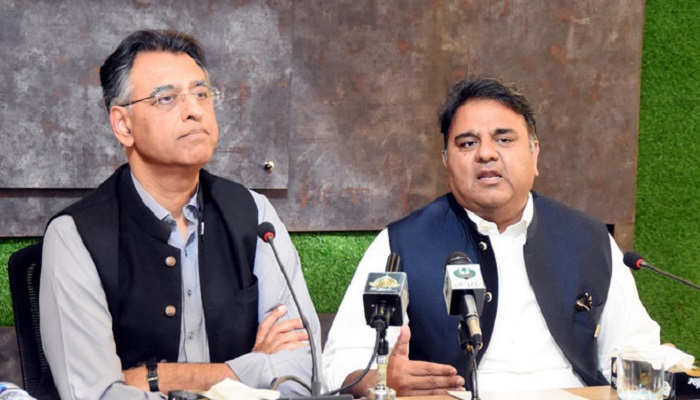 PTI leaders Asad Umar (left) and Chaudhry Fawad Hussain talk to journalists during a press conference in Islamabad, Pakistan, on March 29, 2022. — PID