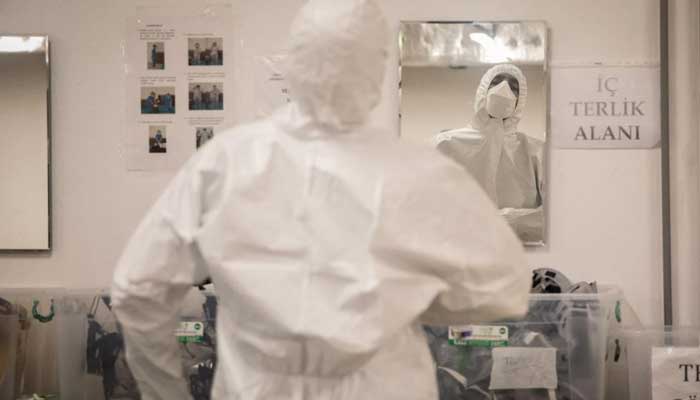A doctor wears personal protective equipment (PPE) before treating COVID-19 patients in a hospital in Istanbul. — AFP