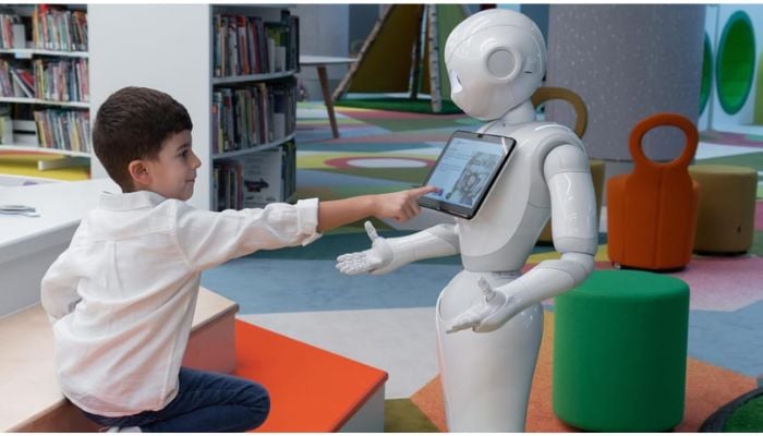 A child meeting Pepper, a humanoid storytelling robot.— Mohammed Bin Rashid library via CNN
