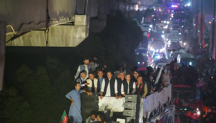PTI leaders on top of a container as PTI Chairman Imran Khan (centre) leads the Haqeeqi Azadi March in Lahore, on October 28, 2022. — Facebook/ImranKhan