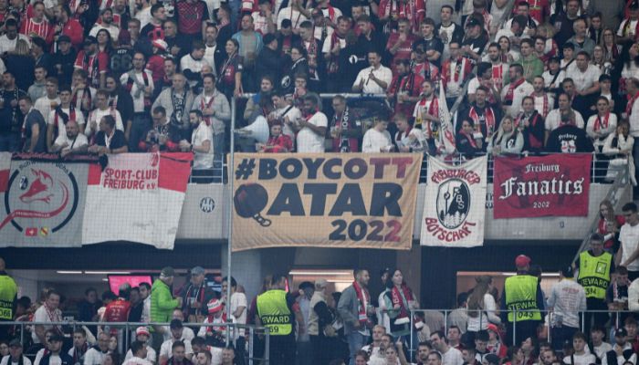 Supporters display a banner reading ´Boycott Qatar 2022´ prior to the start of the UEFA Europa League Group G football match between SC Freiburg and Olympiacos FC in Freiburg im Breisgau, southwestern Germany on October 27, 2022, and ahead of the FIFA World Cup 2022 to be played in Qatar.— AFP