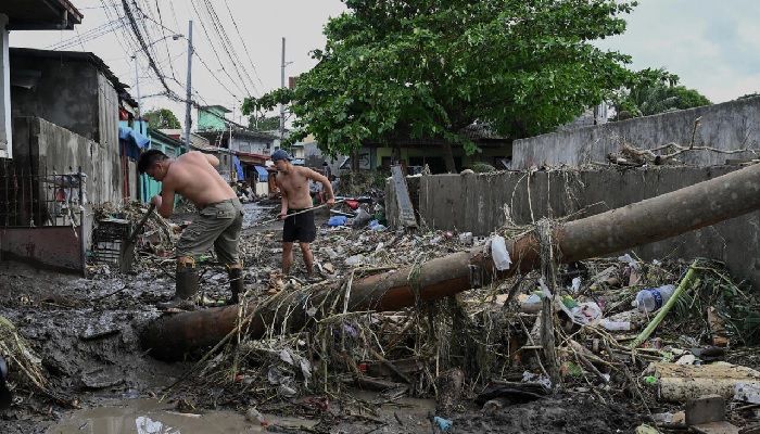 The death toll from floods and landslides unleashed by a tropical storm in the Philippiones jumps sharply to 98. - AFP