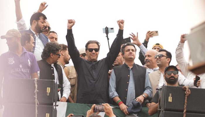 PTI Chairman Imran Khan gestures at the march participants as his convoy arrives in Gujranwala on November 1, 2022. — Instagram