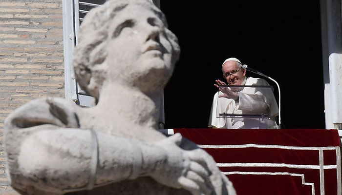 Pope Francis waves from the window of the Apostolic Palace during the weekly Angelus prayer on October 30, 2022 in The Vatican — AFP