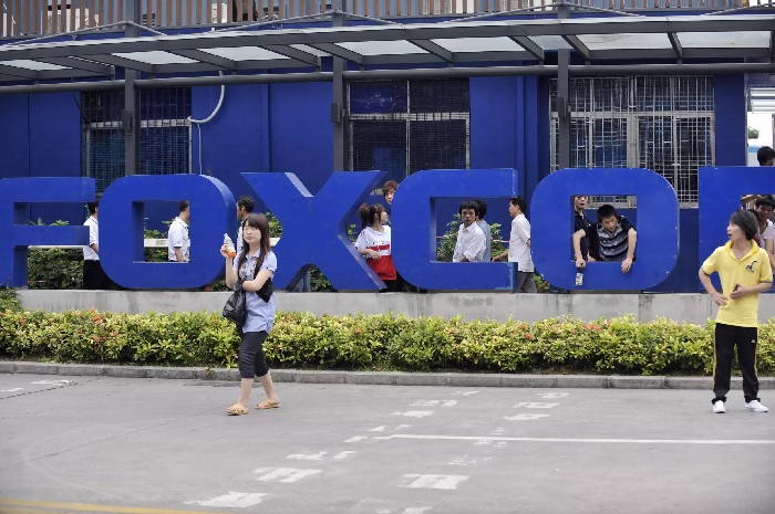 Chinese workers are seen outside Foxconns factory in Shenzhen, in southern Guangdong province, in this file photo. — AFP
