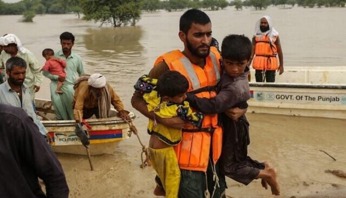 I soccorritori aiutano a evacuare i pakistani colpiti dalle inondazioni dalle loro case colpite dalle inondazioni a seguito delle forti piogge monsoniche nel distretto di Rajanpur, nella provincia del Punjab, il 27 agosto 2022.— AFP