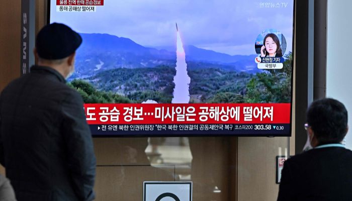 In this file photo taken on November 2, 2022, people watch a television screen showing a news broadcast with file footage of a North Korean missile test, at a railway station in Seoul.— AFP