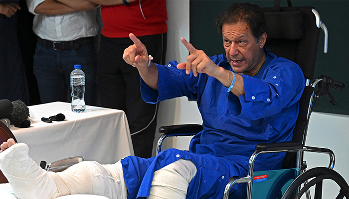 In this picture taken on on November 4, 2022, former prime minister Imran Khan addresses the media representatives at a hospital in Lahore, a day after an assassination attempt on him. — AFP