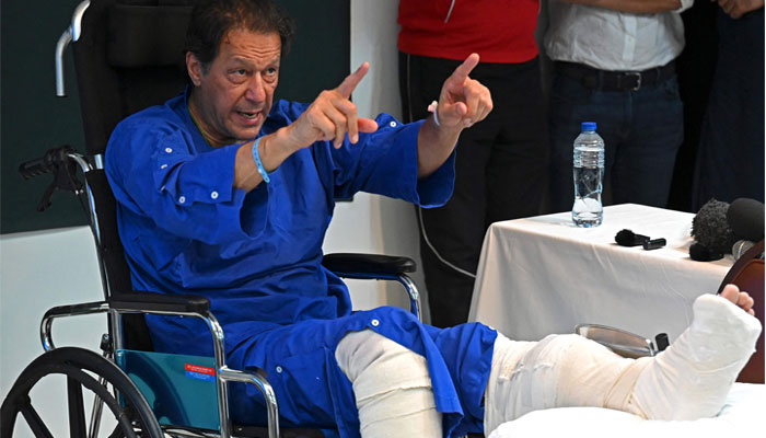 In this picture taken on on November 4, 2022, Pakistan´s former prime minister Imran Khan addresses the media representatives at a hospital in Lahore, a day after an assassination attempt on him. — AFP