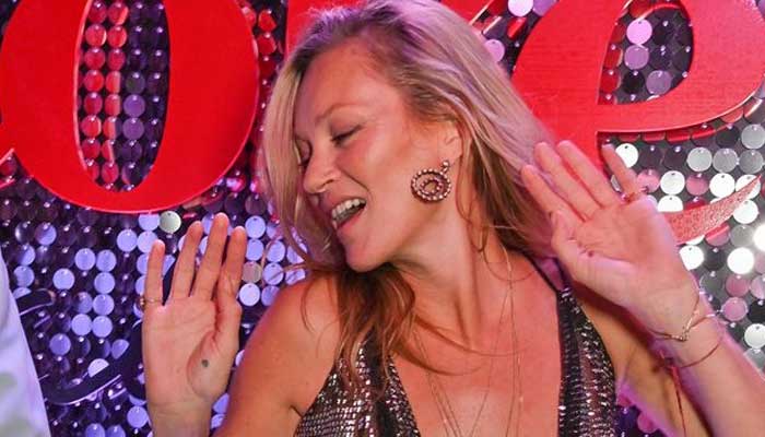 Kate Moss busts out her best moves as she dances with pals at glitzy brand event