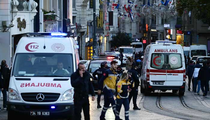 Ambulances ride as Turkish policemen try to secure the area after a strong explosion of unknown origin shook the busy shopping street of Istiklal in Istanbul, on November 13, 2022. —AFP