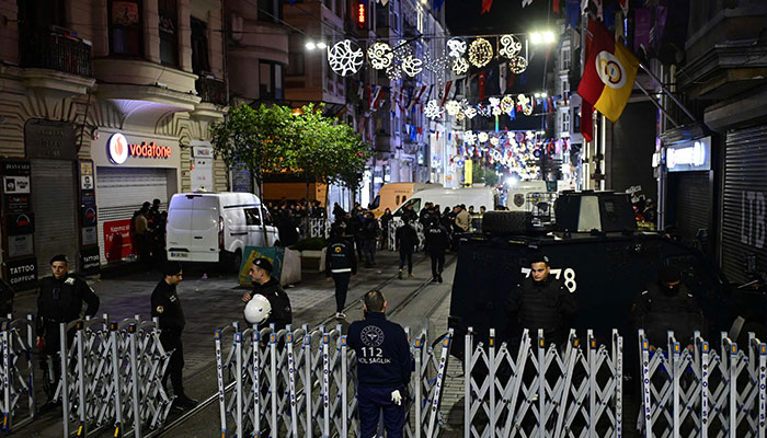 Turkish policemen secure the area after a strong explosion of unknown origin shook the busy shopping street of Istiklal in Istanbul, on November 13, 2022. — AFP