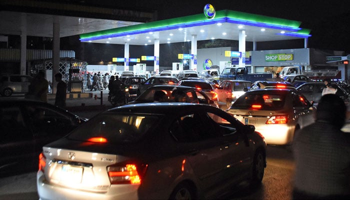 Motorists wait to fill their vehicle tanks at a petrol station in Islamabad following an increase of petroleum prices by the government. — Online/File