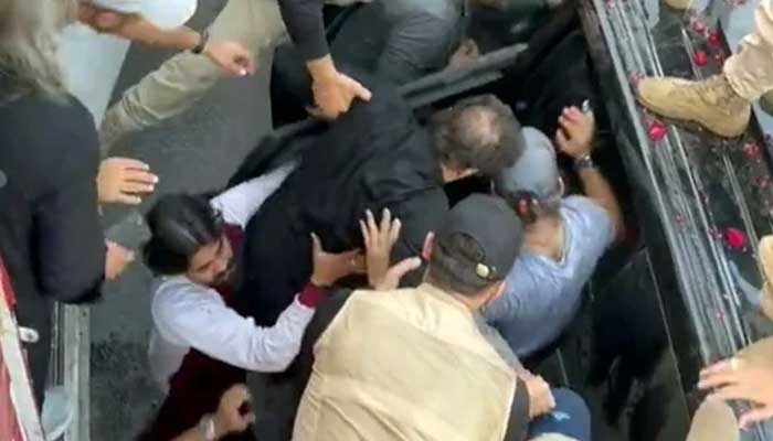 PTI Chairman Imran Khan being evacuated in a bulletproof vehicle after a man opened burst fire at his container in Gujranwala, on November 3, 2022. — YouTube Screengrab via Geo News