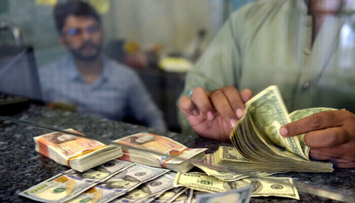 A currency dealer works at an exchange company. — AFP/File