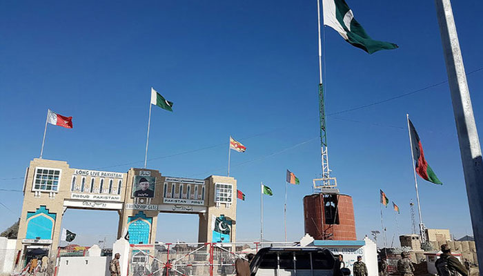 In this photograph taken on January 7, 2017, Pakistan security personnel look on as travellers wait to cross the border between Pakistan and Afghanistan at Chaman. — AFP