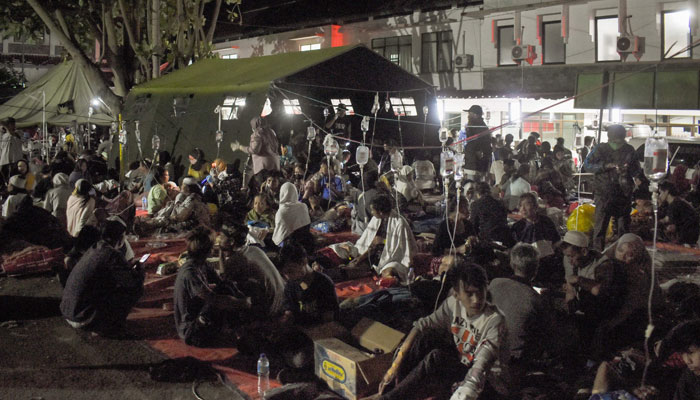 Wounded survivors of an earthquake are being treated in the yard of a hospital in Cianjur on November 21, 2022. — AFP
