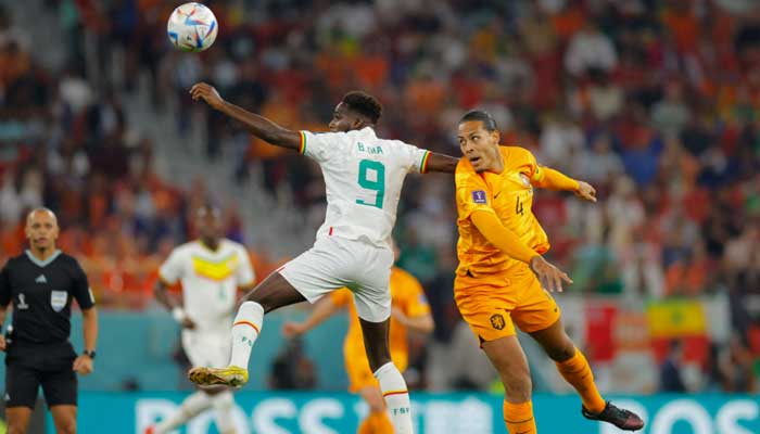 Senegal´s forward Boulaye Dia (L) and Netherlands’ defender Virgil van Dijk jump for the ball during the Qatar 2022 World Cup Group A football match between Senegal and the Netherlands at the Al-Thumama Stadium in Doha on November 21, 2022. —AFP