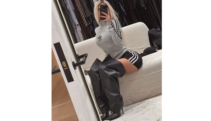 Kim Kardashian soars temperature in dramatic black boots and matching shorts