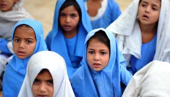 Little girls attend a class in an open classroom in Pakistan. — AFP/File