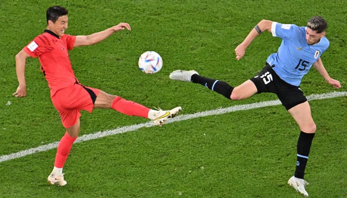 South Koreas midfielder #05 Jung Woo-young (L) fights for the ball with Uruguays midfielder #15 Federico Valverde (R) during the Qatar 2022 World Cup Group H football match between Uruguay and South Korea at the Education City Stadium in Al-Rayyan, west of Doha on November 24, 2022. — AFP