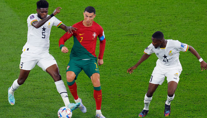 Portugals forward #07 Cristiano Ronaldo is marked by Ghana´s midfielder #05 Thomas Partey and Ghanas midfielder #21 Salis Abdul Samed during the Qatar 2022 World Cup Group H football match between Portugal and Ghana at Stadium 974 in Doha on November 24, 2022. — AFP