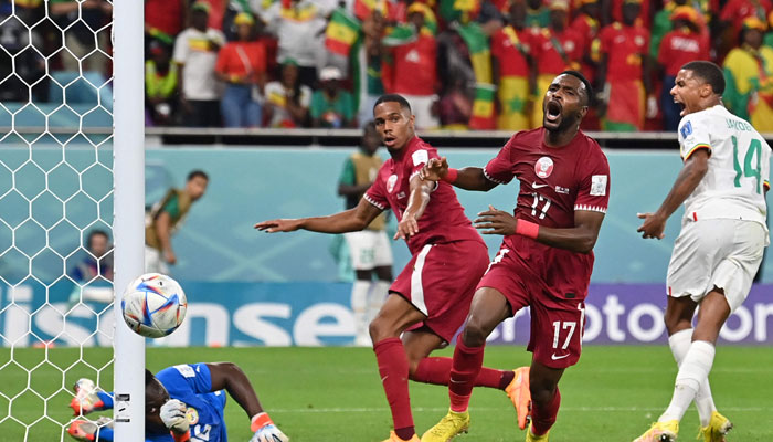 Qatars defender #17 Ismaiel Mohammed (2R) reacts after Senegals goalkeeper #16 Edouard Mendy (L) makes a save during the Qatar 2022 World Cup Group A football match between Qatar and Senegal at the Al-Thumama Stadium in Doha on November 25, 2022. — AFP/File