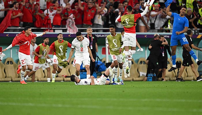 Morocco players celebrate after Moroccos forward #14 Zakaria Aboukhlal (unseen) scored his teams second goal during the Qatar 2022 World Cup Group F football match between Belgium and Morocco at the Al-Thumama Stadium in Doha on November 27, 2022. — AFP