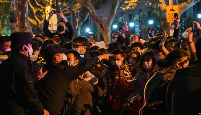 Police and people are seen during some clashes in Shanghai on Nov. 27, 2022, where protests against Chinas zero-Covid policy took place the night before following a deadly fire in Urumqi, the capital of the Xinjiang region. — AFP