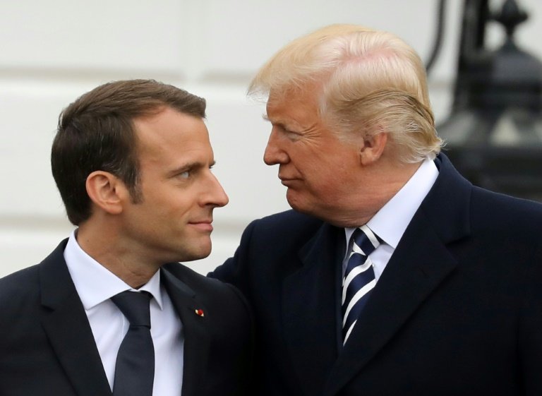 Macron tried to woo Bidens predecessor Donald Trump (R) early in his term. - AFP