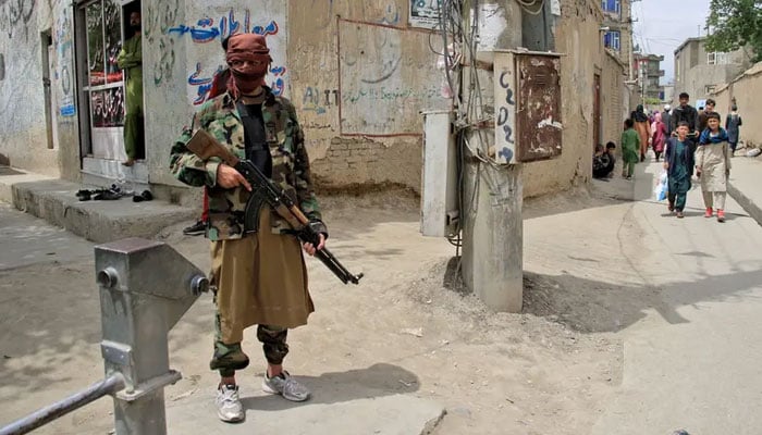 A Taliban fighter stands guard at the site of an explosion in Kabul, Afghanistan, on April 19, 2022. — AFP/File