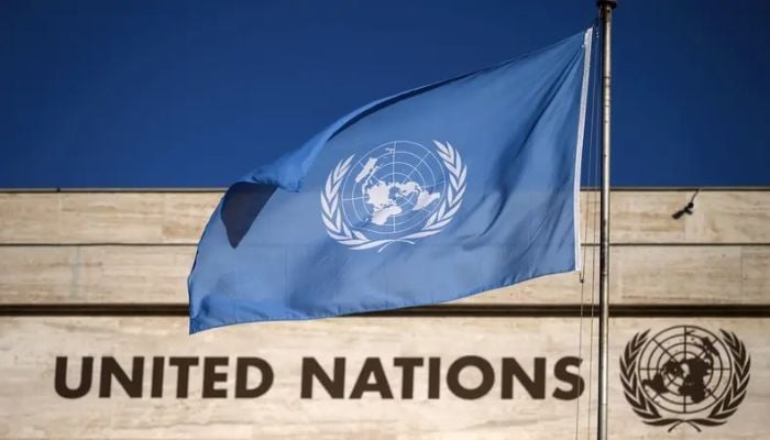 A flag of the United Nations flutters in wind at the main entrance of the Palais des Nations building which houses the United Nations Offices in Geneva, on September 29, 2021.— AFP