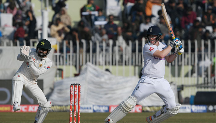 England’s Harry Brook (R) plays a shot as Pakistan’s wicketkeeper Mohammad Rizwan watches during the fourth day of the first cricket Test match between Pakistan and England at the Rawalpindi Cricket Stadium, in Rawalpindi on December 4, 2022. — AFP