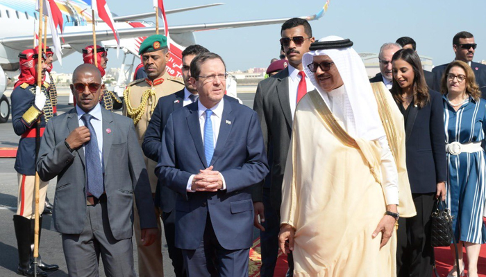 Israeli President Isaac Herzog (centre) greeted by Bahraini Foreign Minister Abdullatif al-Zayani after arriving in Bahrain on December 4, 2022. — Twitter/@Isaac_Herzog