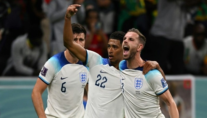 Englands Jordan Henderson celebrates with Jude Bellingham after scoring against Senegal. - AFP