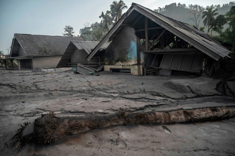 Damaged houses inundated with mud in the village of Kajar Kuning following the eruption of Mount Semeru. - AFP