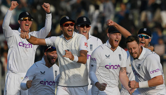 Englands players celebrate after the dismissal of Pakistans Salman Ali Agha (not pictured) during the fifth and final day of the first cricket Test match between Pakistan and England at the Rawalpindi Cricket Stadium, in Rawalpindi on December 5, 2022. — AFP
