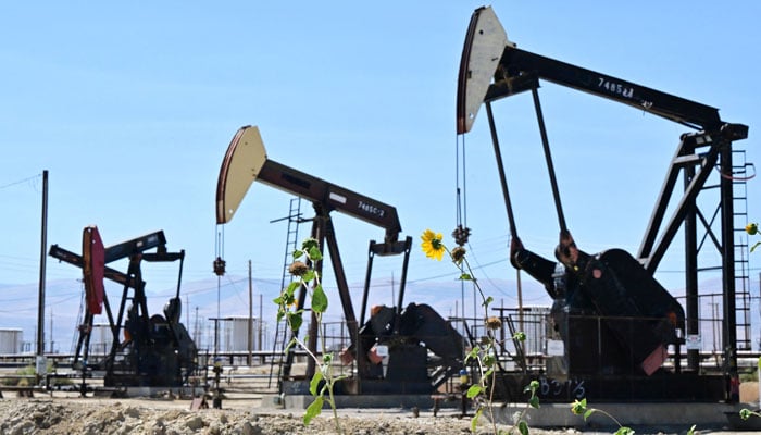 In this file photo taken on September 28, 2022 oil pumpjacks are seen along a section of Highway 33 known as the Petroleum Highway north of McKittrick in Kern County, California on September 28, 2022. — AFP