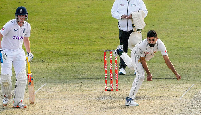Pakistan´s Haris Rauf (R) delivers the ball England´s Harry Brook (L) watches during the first day of the first cricket Test match between Pakistan and England at the Rawalpindi Cricket Stadium, in Rawalpindi on December 1, 2022. — AFP