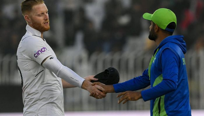 England skipper Ben Stokes (left) shakes hands with his Pakistan counterpart Babar Azam at the end of the first Test.— AFP