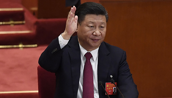 In this file photo taken on October 24, 2017, Chinese President Xi Jinping raises his hand to vote for the reports with other Chinas leaders at the closing of the 19th Communist Party Congress at the Great Hall of the People in Beijing. — AFP