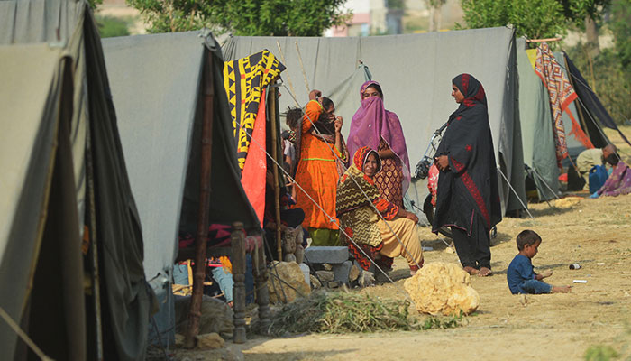 Internally displaced flood-affected women gather at a makeshift camp in Jamshoro district of Sindh province on September 26, 2022. — AFP/File