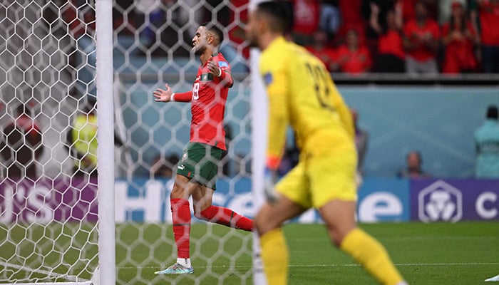 Moroccos forward #19 Youssef En-Nesyri (back) celebrates scoring his teams first goal during the Qatar 2022 World Cup quarter-final football match between Morocco and Portugal at the Al-Thumama Stadium in Doha on December 10, 2022. — AFP