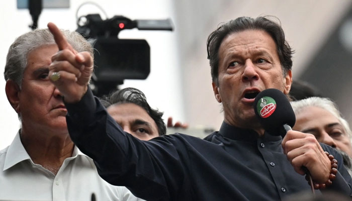 PTI Chairman Imran Khan addressing participants of his partys long march. — AFP