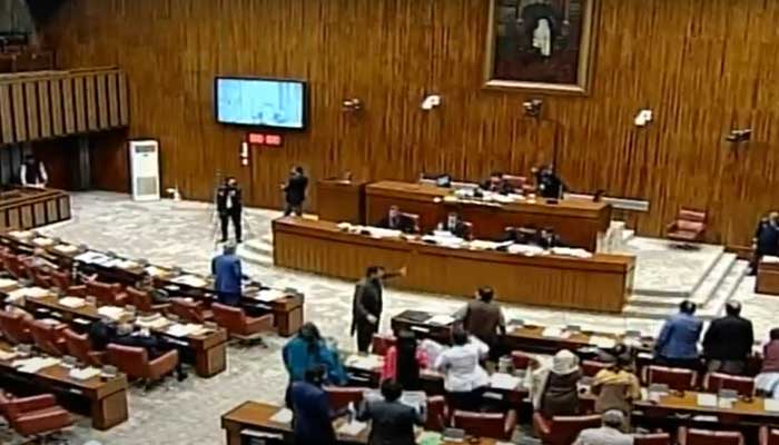 PTI members seen protesting against incarceration of Senator Azam Sawti while the Upper House approves Foreign Investment (Promotion and Protection) Bill, 2022. — Screengrab/YouTube/PTV Parliament