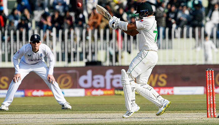 Pakistan´s Azhar Ali (R) plays a shot during the fifth and final day of the first cricket Test match between Pakistan and England at the Rawalpindi Cricket Stadium, in Rawalpindi on December 5, 2022. — AFP