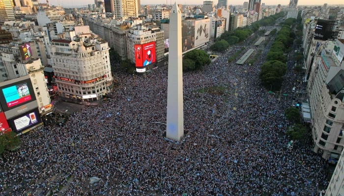 In this aerial view fans of Argentina celebrate their team´s victory after the Qatar 2022 World Cup semifinal football match between Croatia and Argentina at the Obelisk in Buenos Aires on December 13, 2022. — AFP